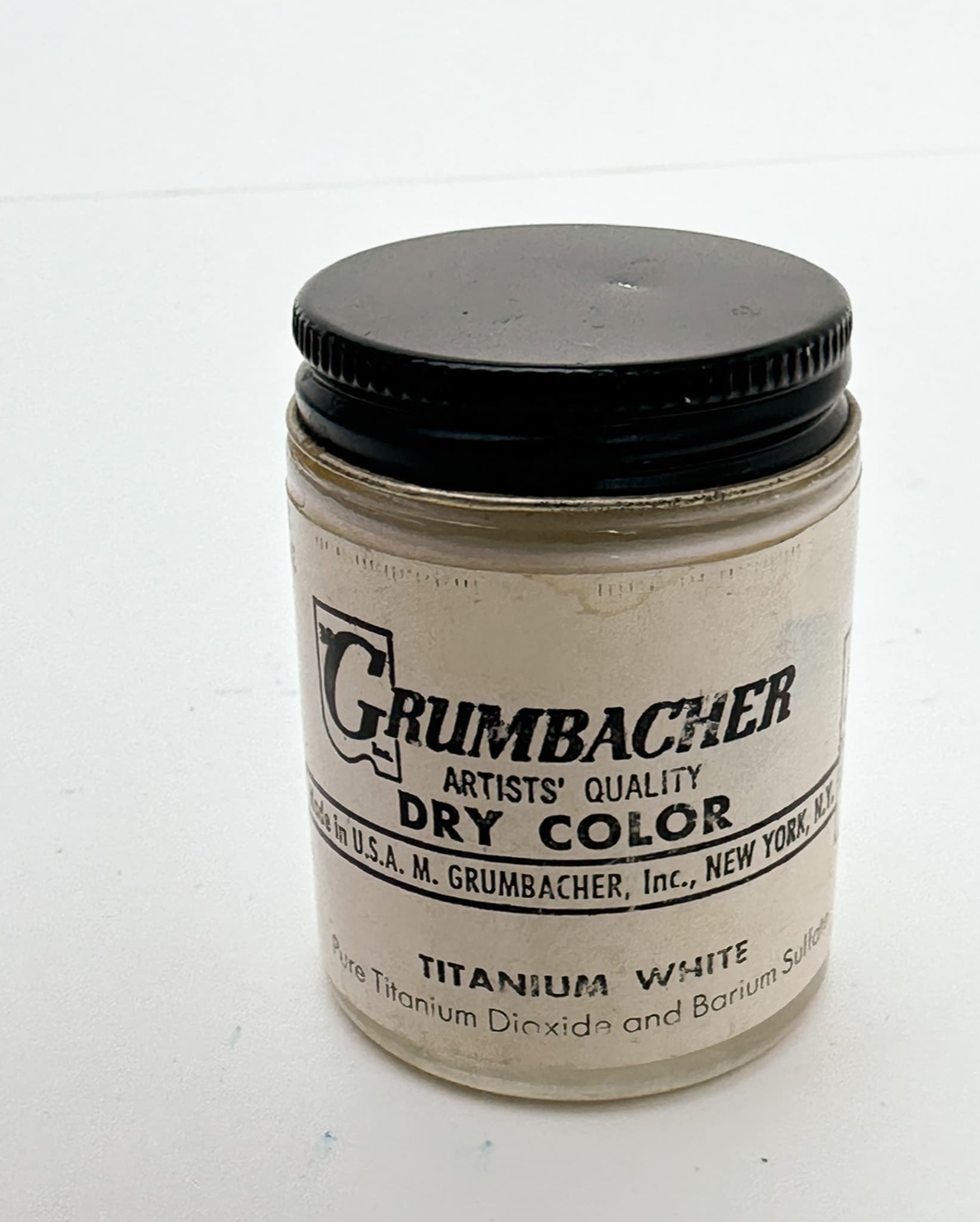 A jar of PW6 Pigment that reads, "Grumbacher Artists' Quality Dry Color Titanium White"