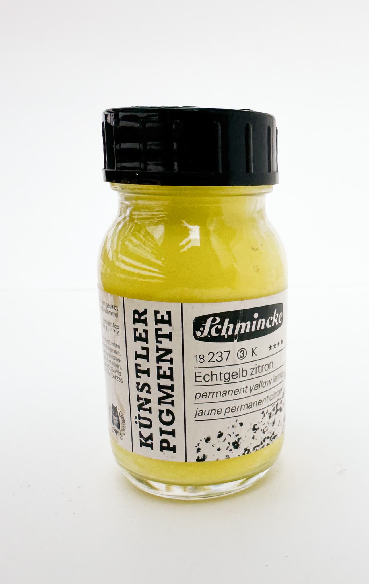 A bottle of bright yellow pigment from Schmincke