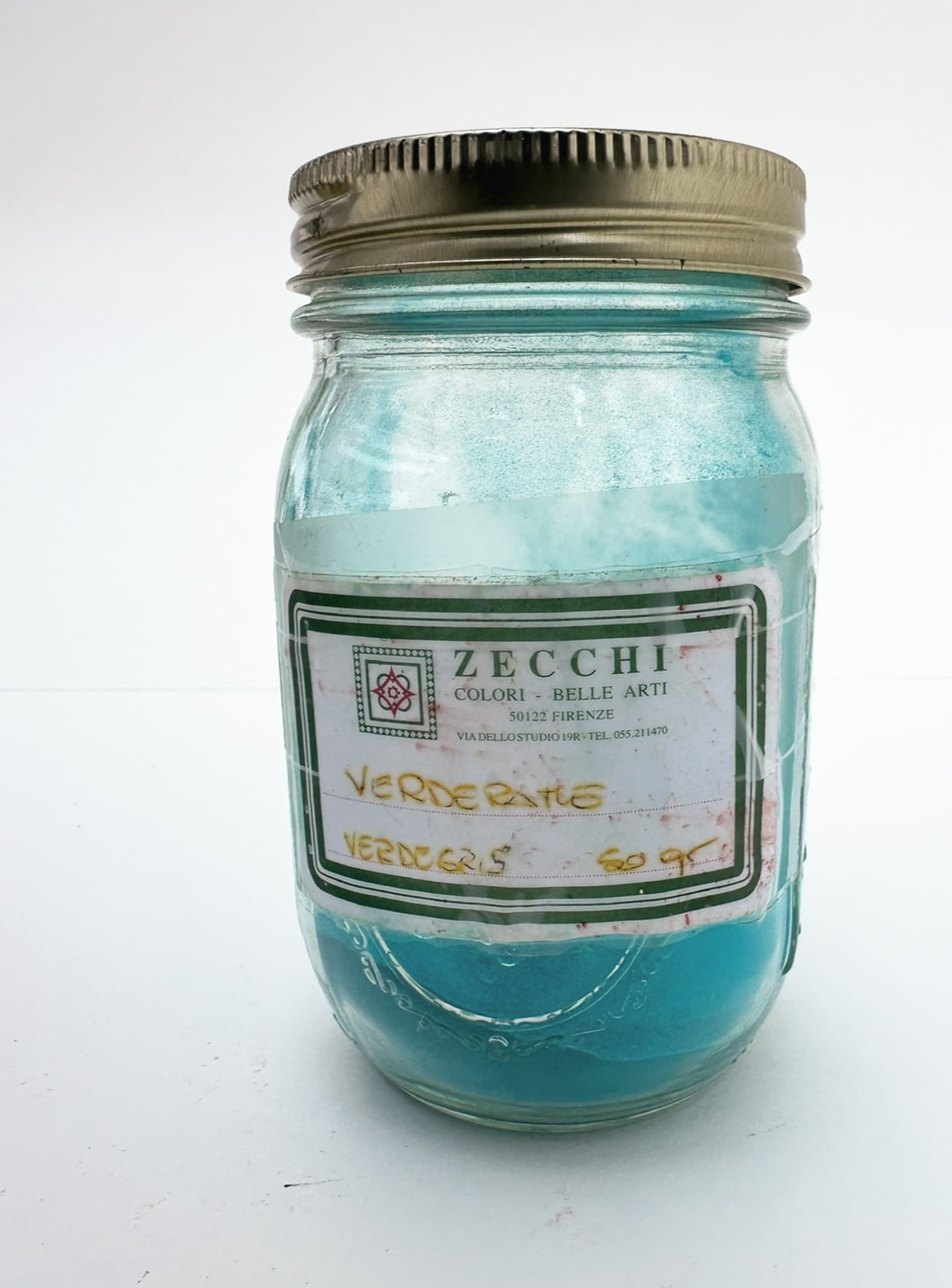 A jar of green verdigris pigment