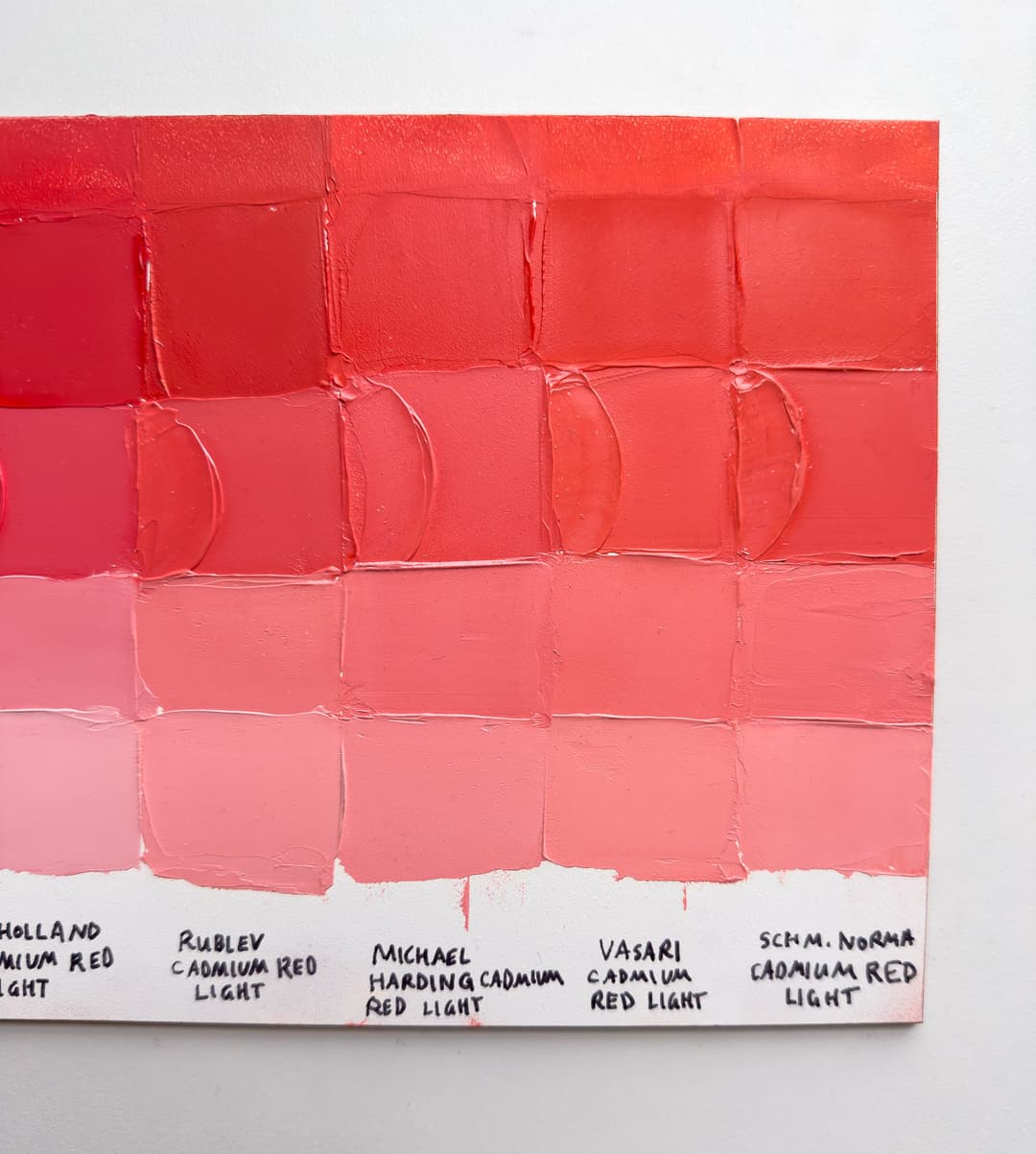 A panel of cadmium red light paints tinted with Titanium White