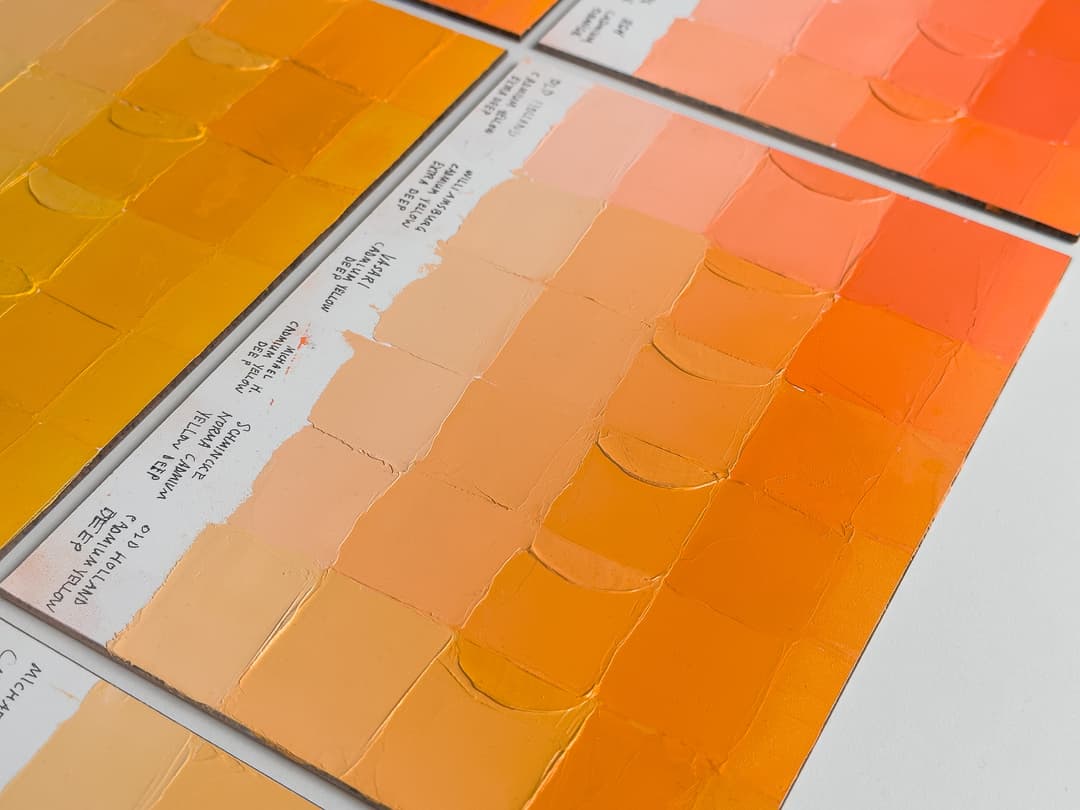 Swatches of artist paint displaying the color differences between brands of oil paint in Cadmium Yellow Deep PY35 and related pigments