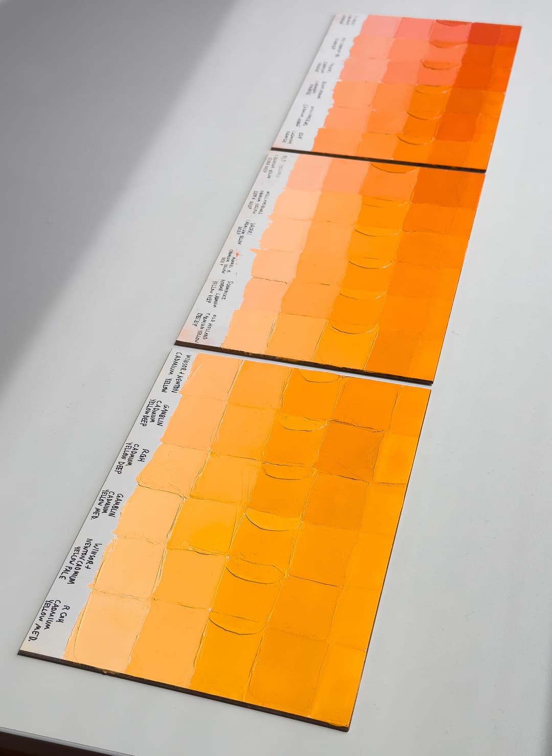 Cadmium Yellow and Cadmium Orange Color Comparison. Three panels show many different colors of yellow-orange from various paint manufacturers