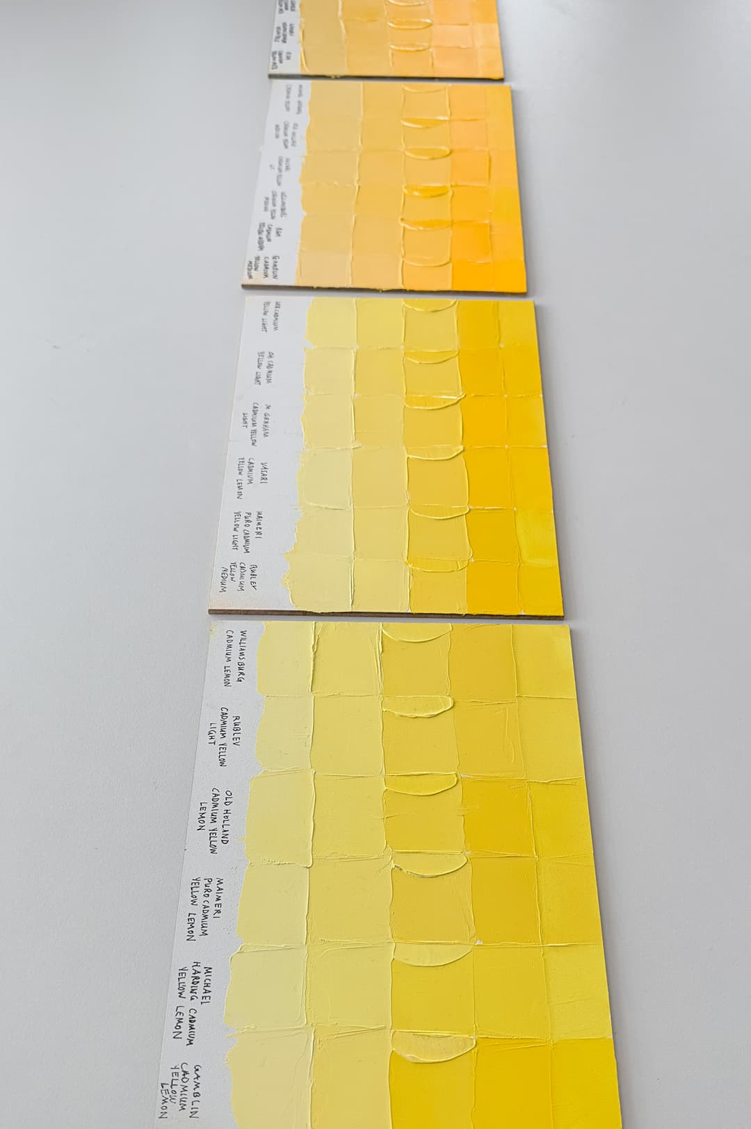 Three panels show various kinds of cadmium yellow. There is an orangy-yellow panel, a primary or mid-yellow panel which is the Cadmium Yellow Lights, and a more lemony yellow panel, which represents the Cadmium Yellow Lemons