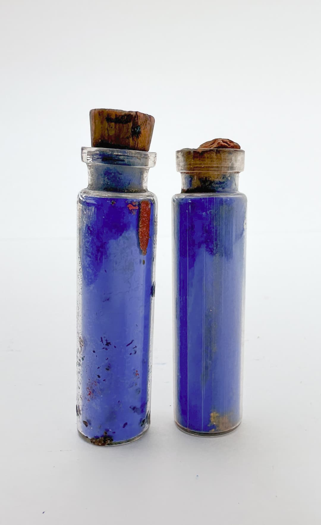 Two vials of blue pigment
