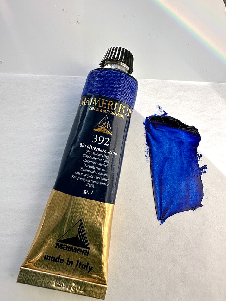 A tube of Maimieri Puro Ultramarine Blue with a swatch of color in masstone