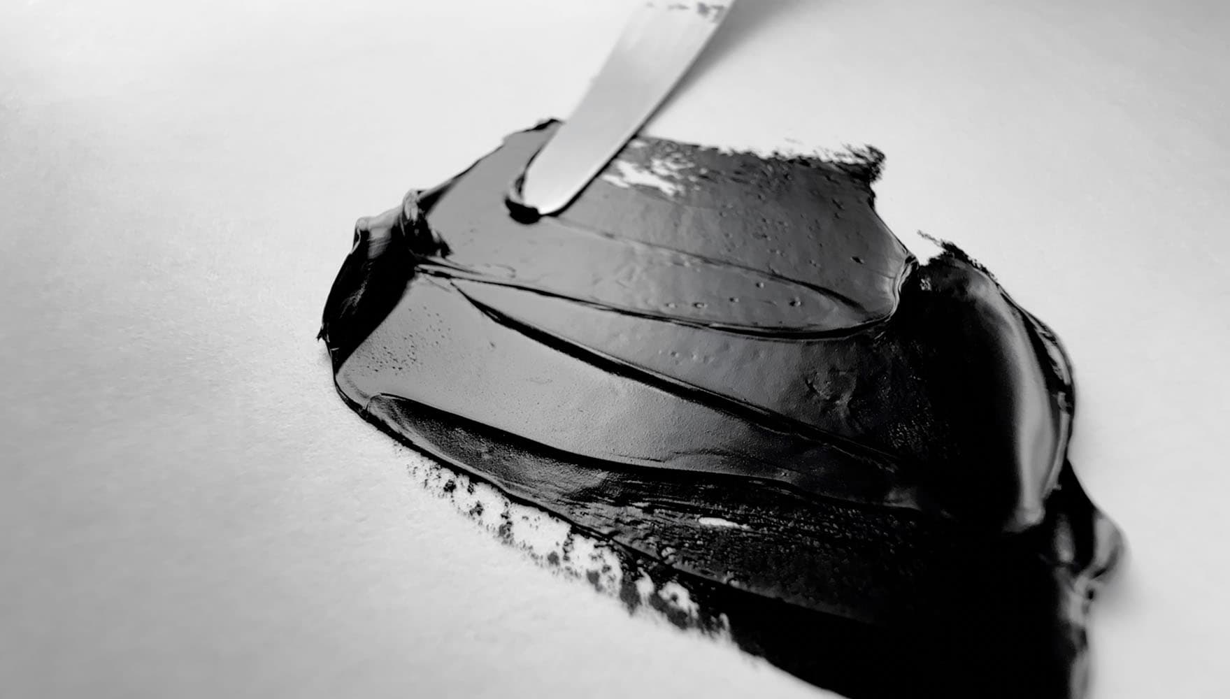 An impasto stroke of Mars Black oil paint