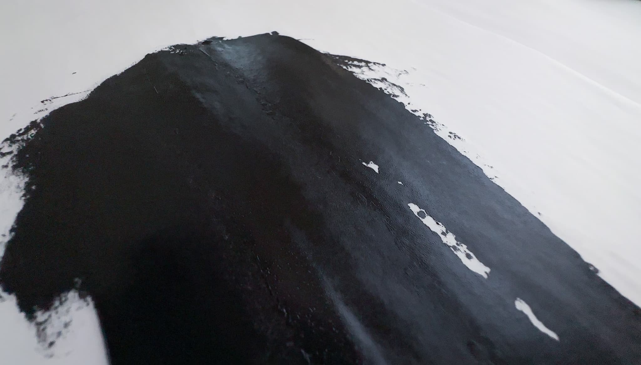 Thin runs of Michael Harding Lamp Black oil paint are quite opaque