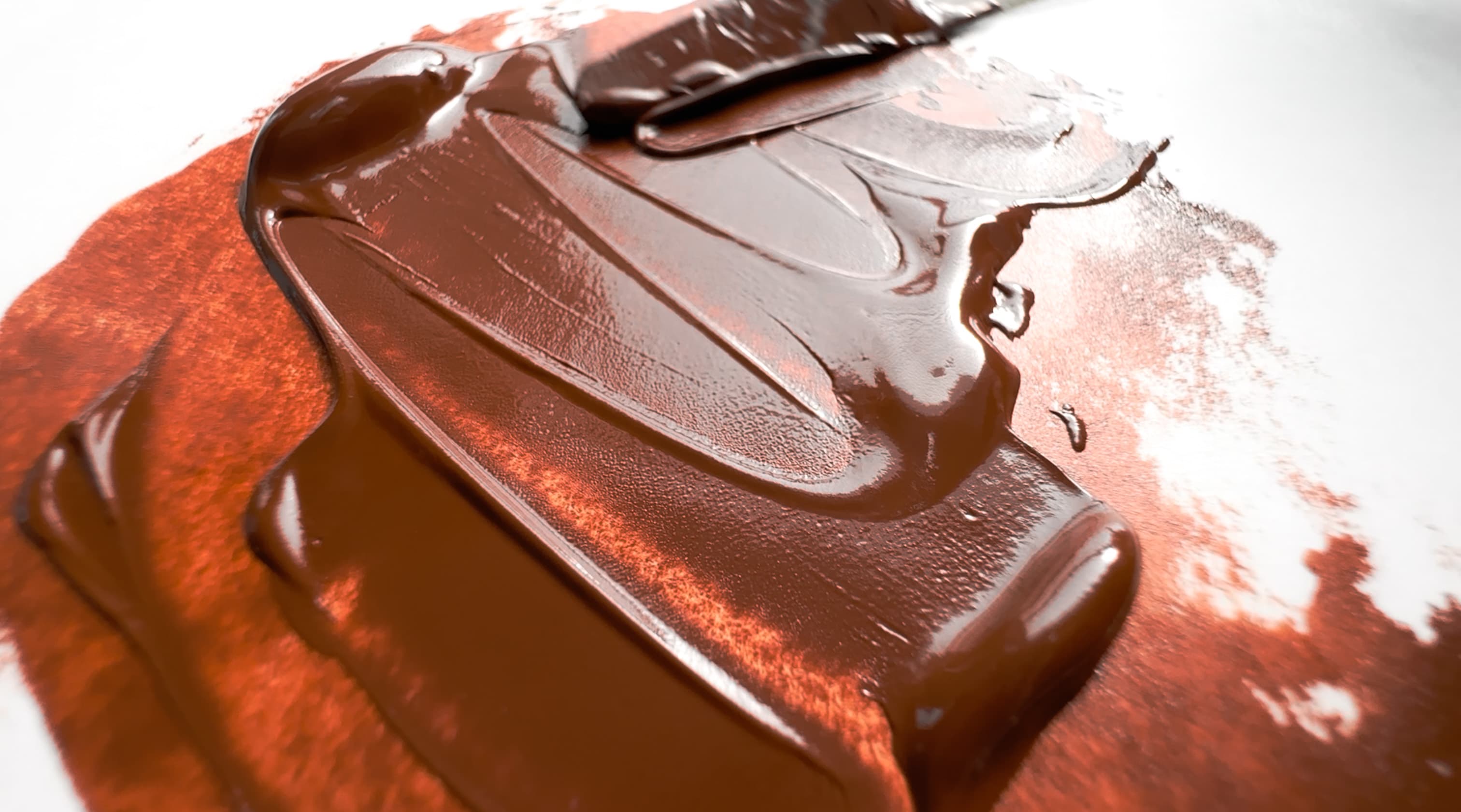 A stroke of oil paint made with a warm brown earth, or brown iron oxide PBr7