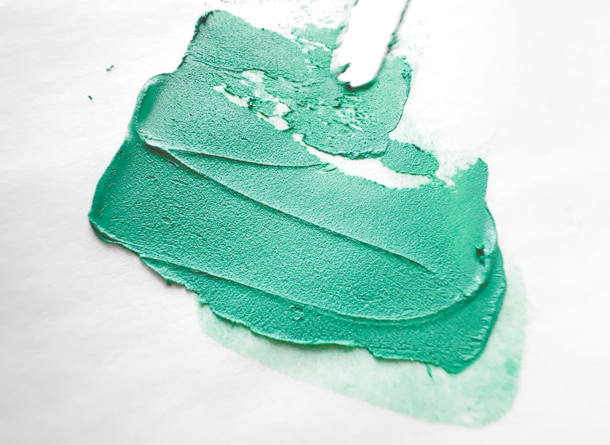 Swoosh of pale green oil paint made with malachite