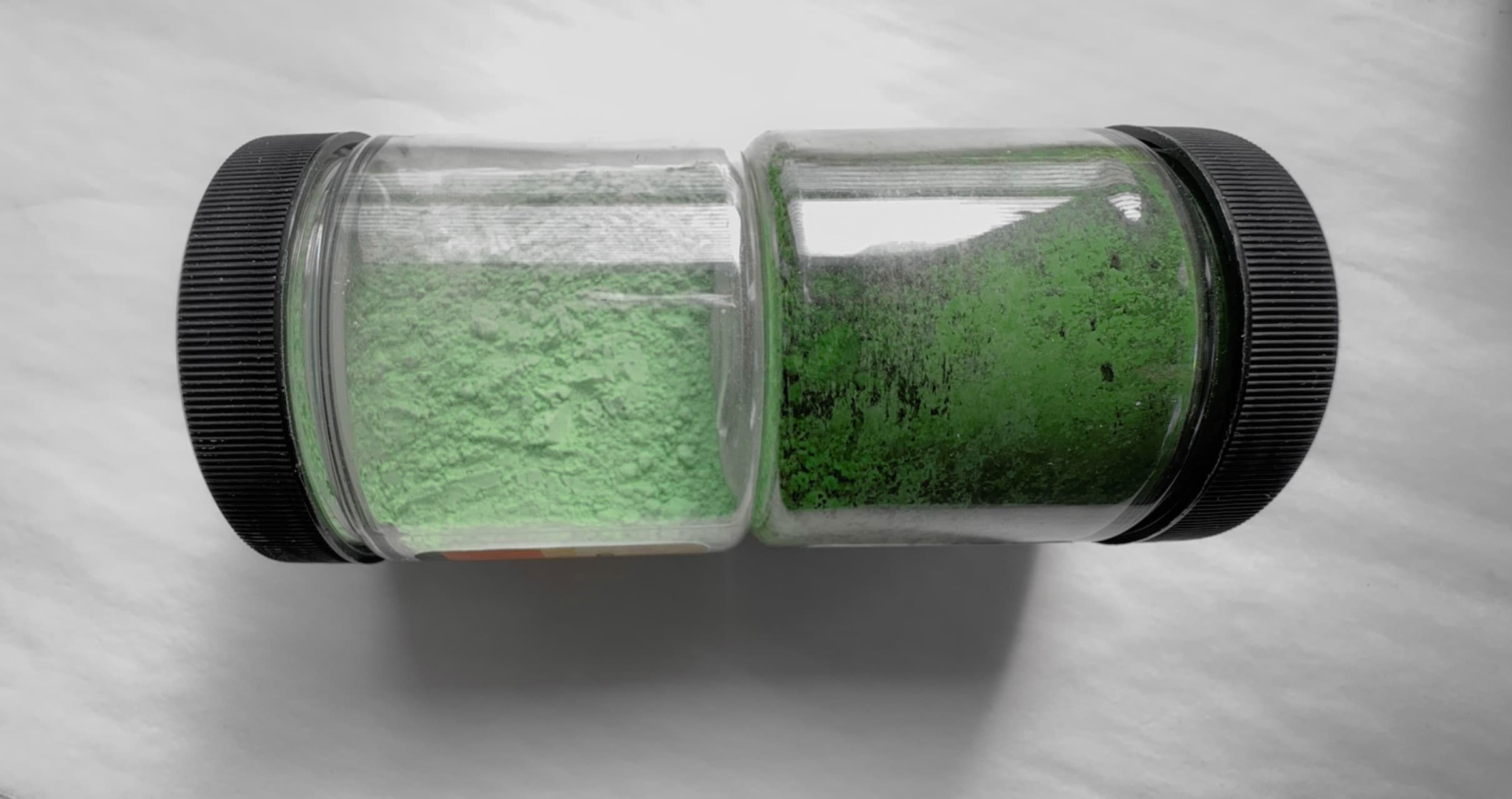 Two bottles of dry pigment. Victoria Green is much more pale and delicate than Chromium Oxide Green, which is a strong olive color