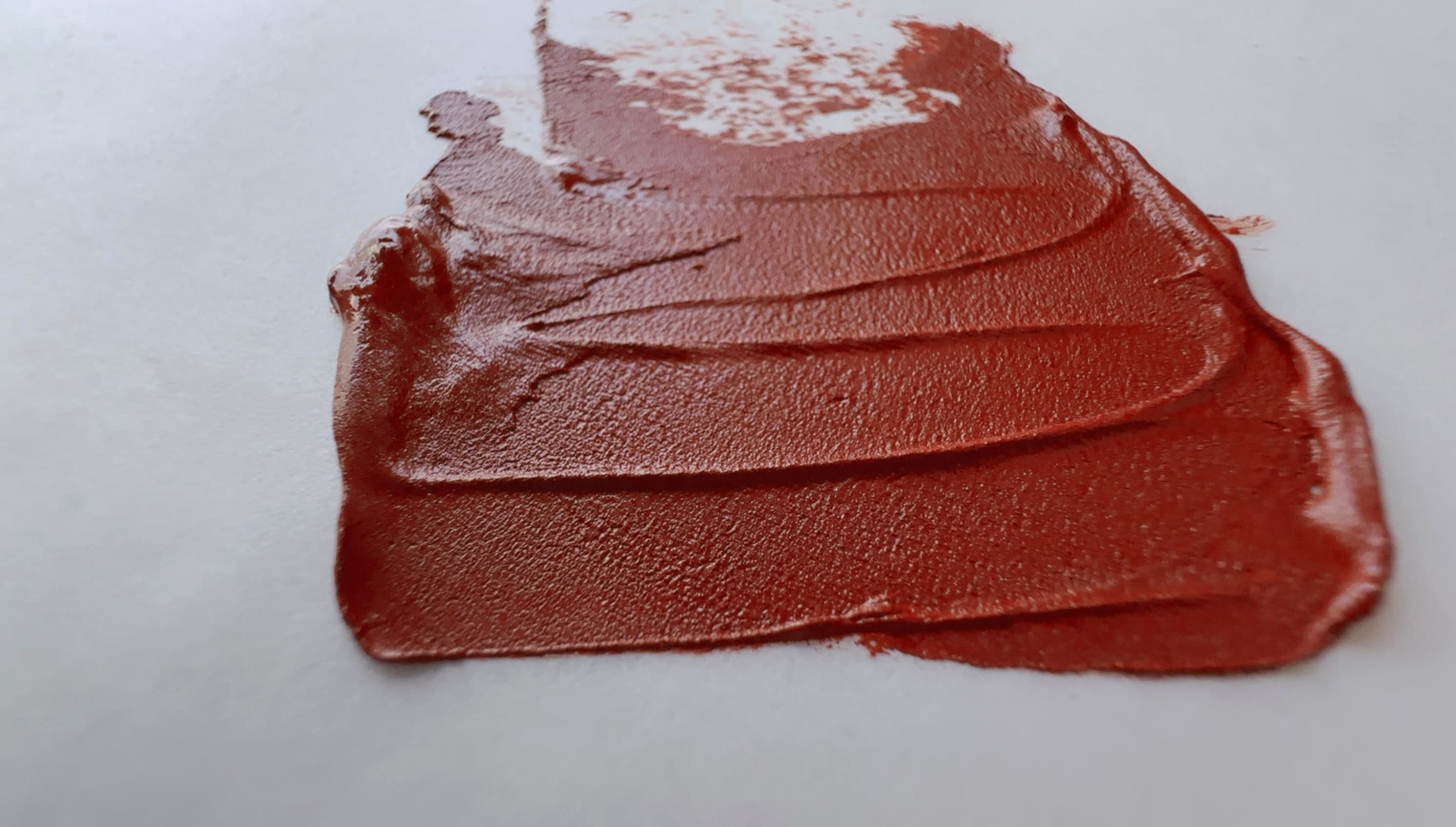 A swoosh of genuine red earth oil paint