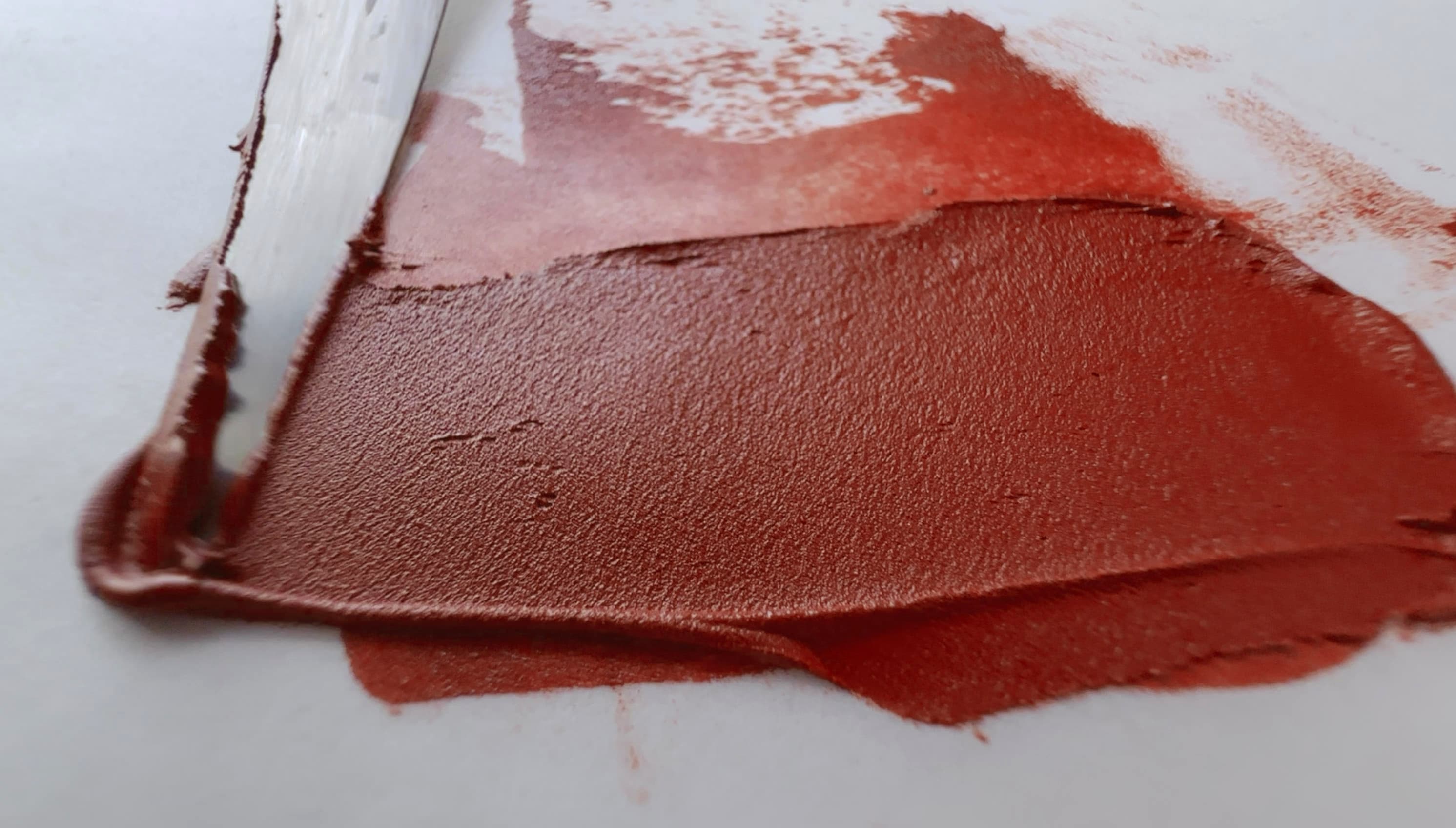 A swath of red earth oil paint made with a palette knife