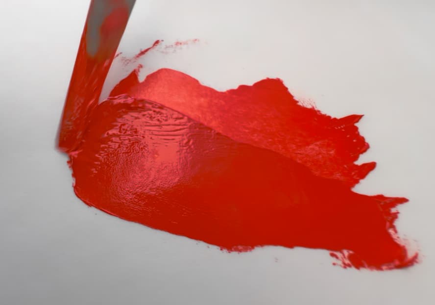 A swatch of red oil paint made with vintage mercadmium red