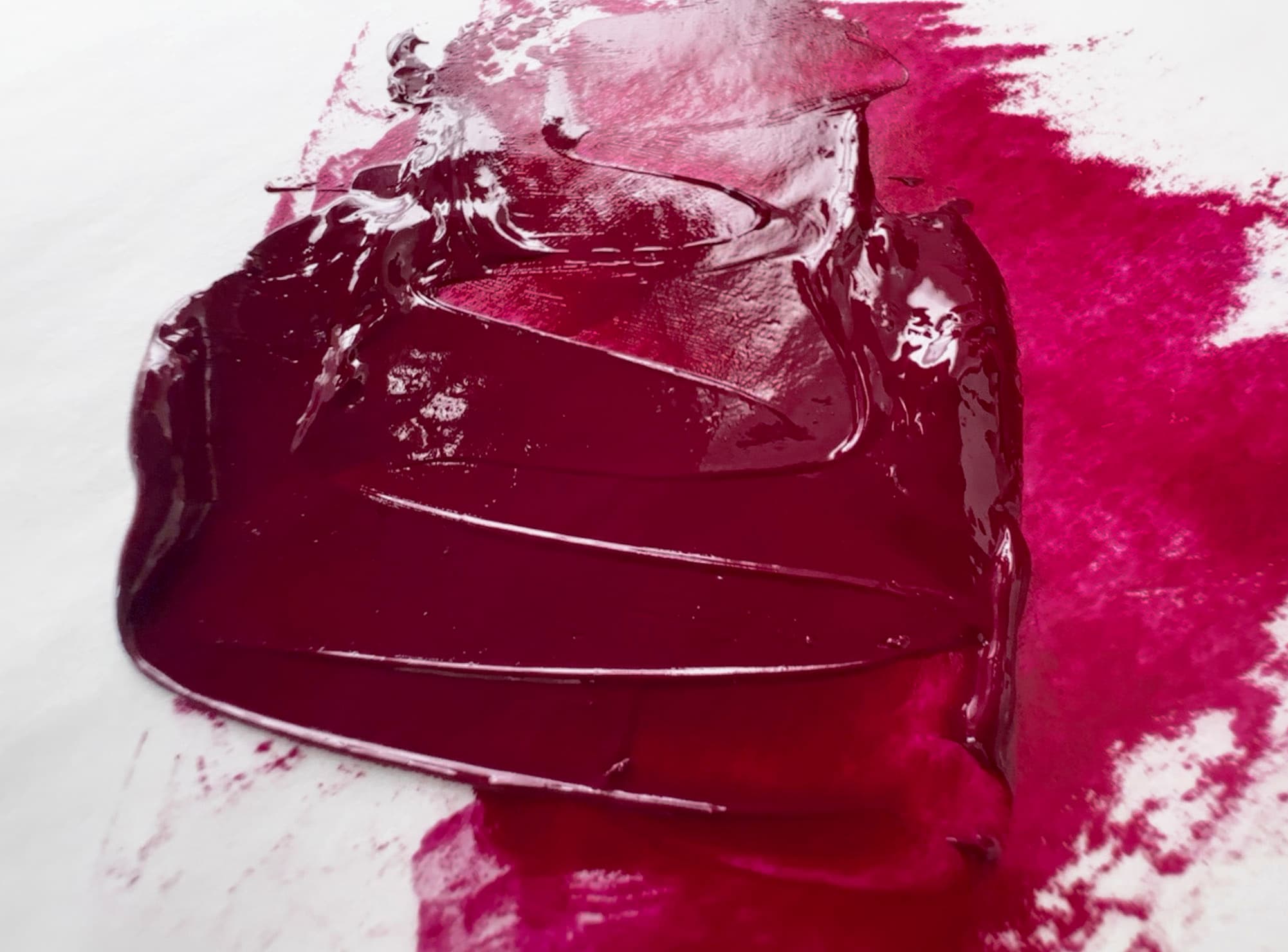 A bit of Michael Harding magenta oil paint pulled by a palette knife