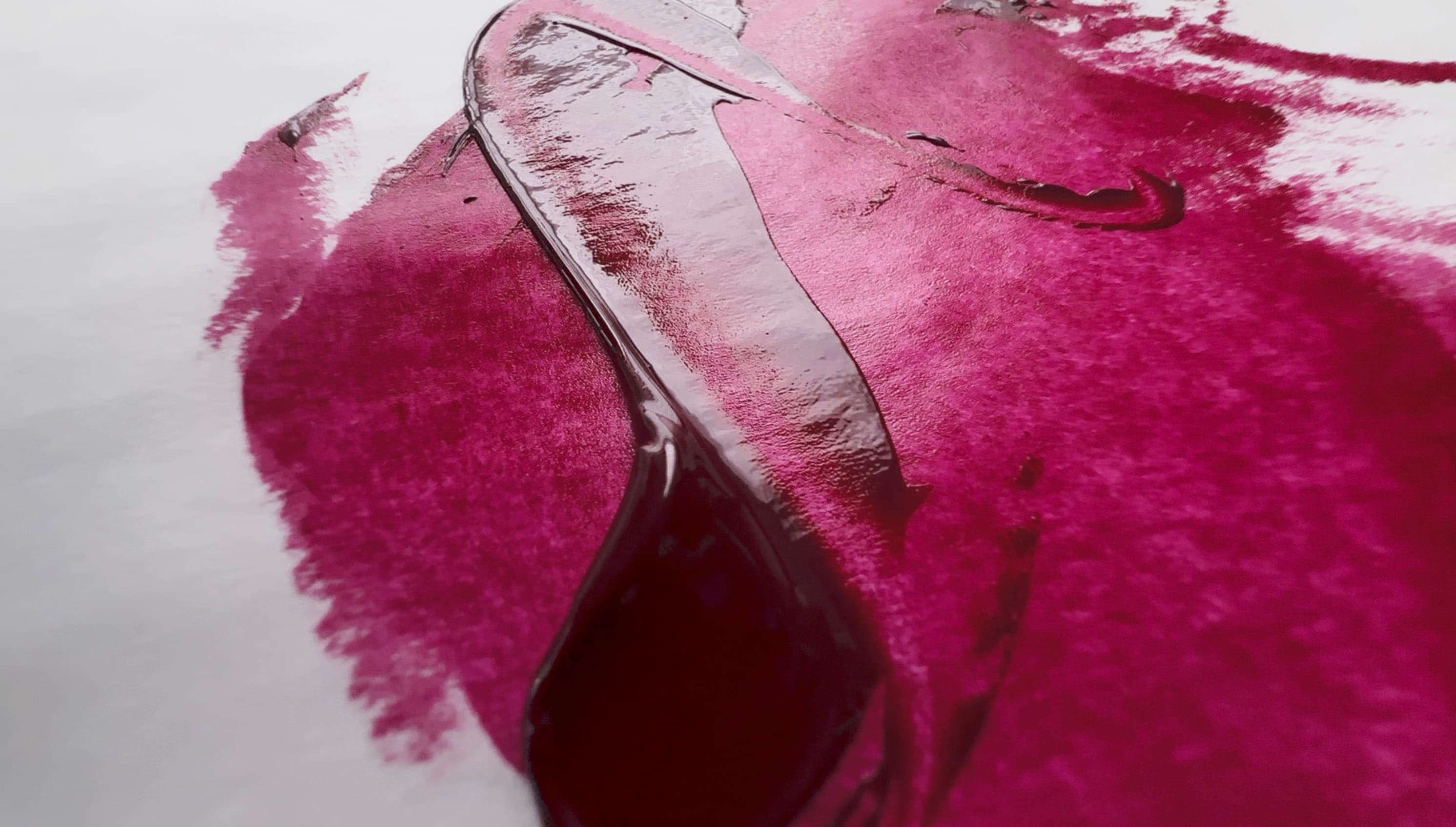A swirl of magenta oil paint