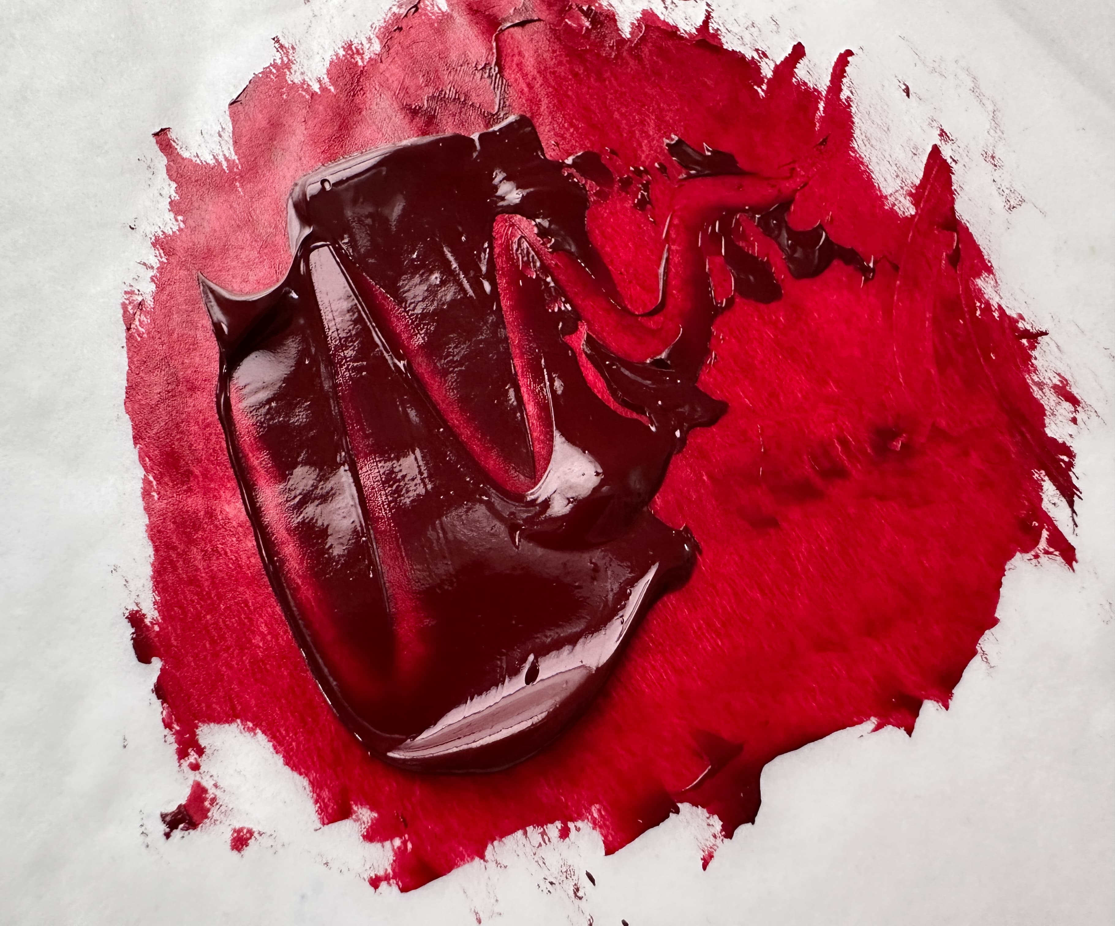 A swoosh of deep red oil paint