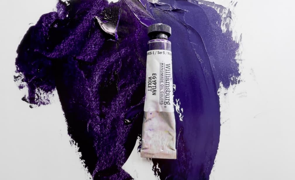 A tiny tube of Williamsburg dioxazine violet, alongside a swatch of paint in masstone as well as a tint. Dioxazine is a powerful tinter