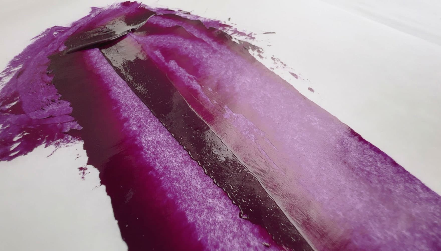 Bright purple oil paint spread with a palette knife