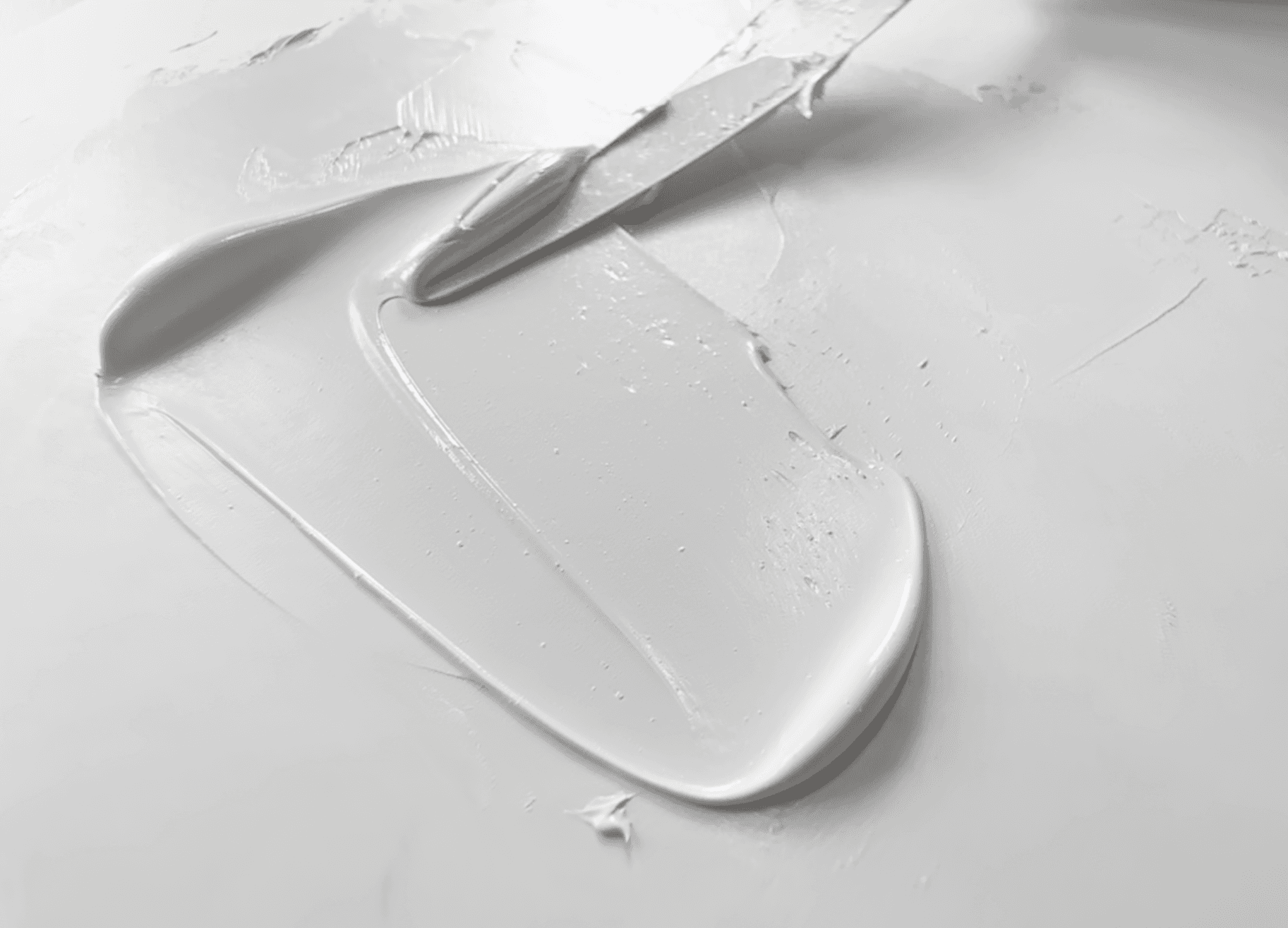 A swoosh of white oil paint made with PW6