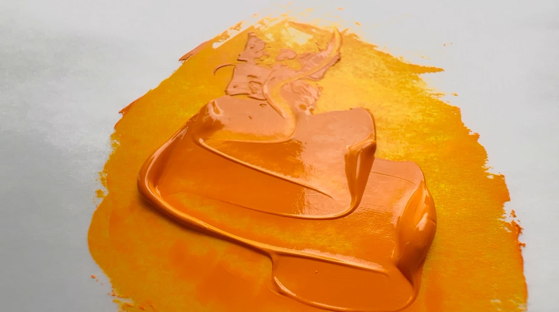A swoosh of bright marigold oil paint made of Isoindolinone Yellow