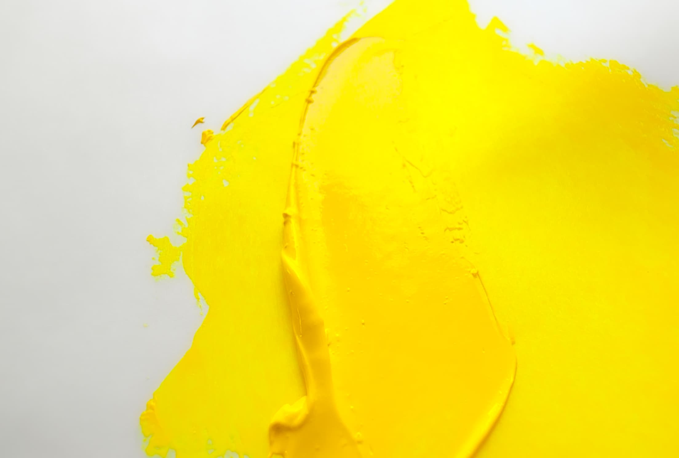 A stroke of bright yellow oil paint