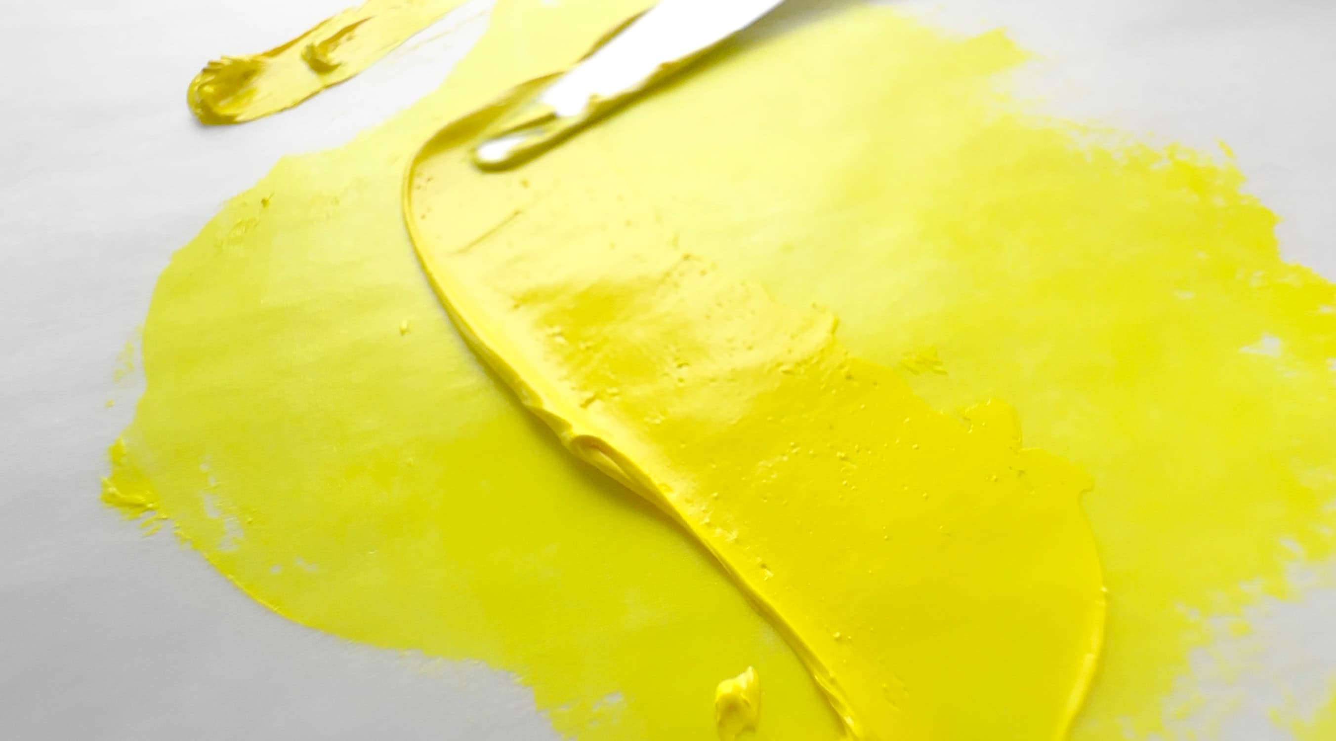 A stroke of bright yellow oil paint