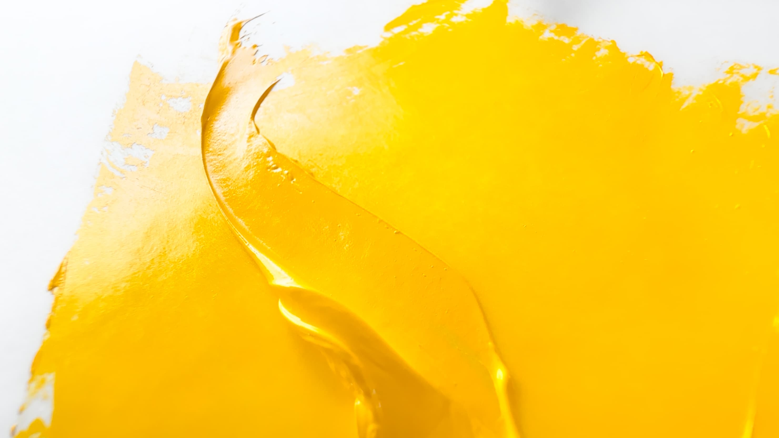 An impasto stroke of yellow oil paint
