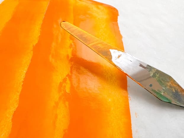 Diarylide Yellow transparent pigment in oil paint spread thinly with a palette knife