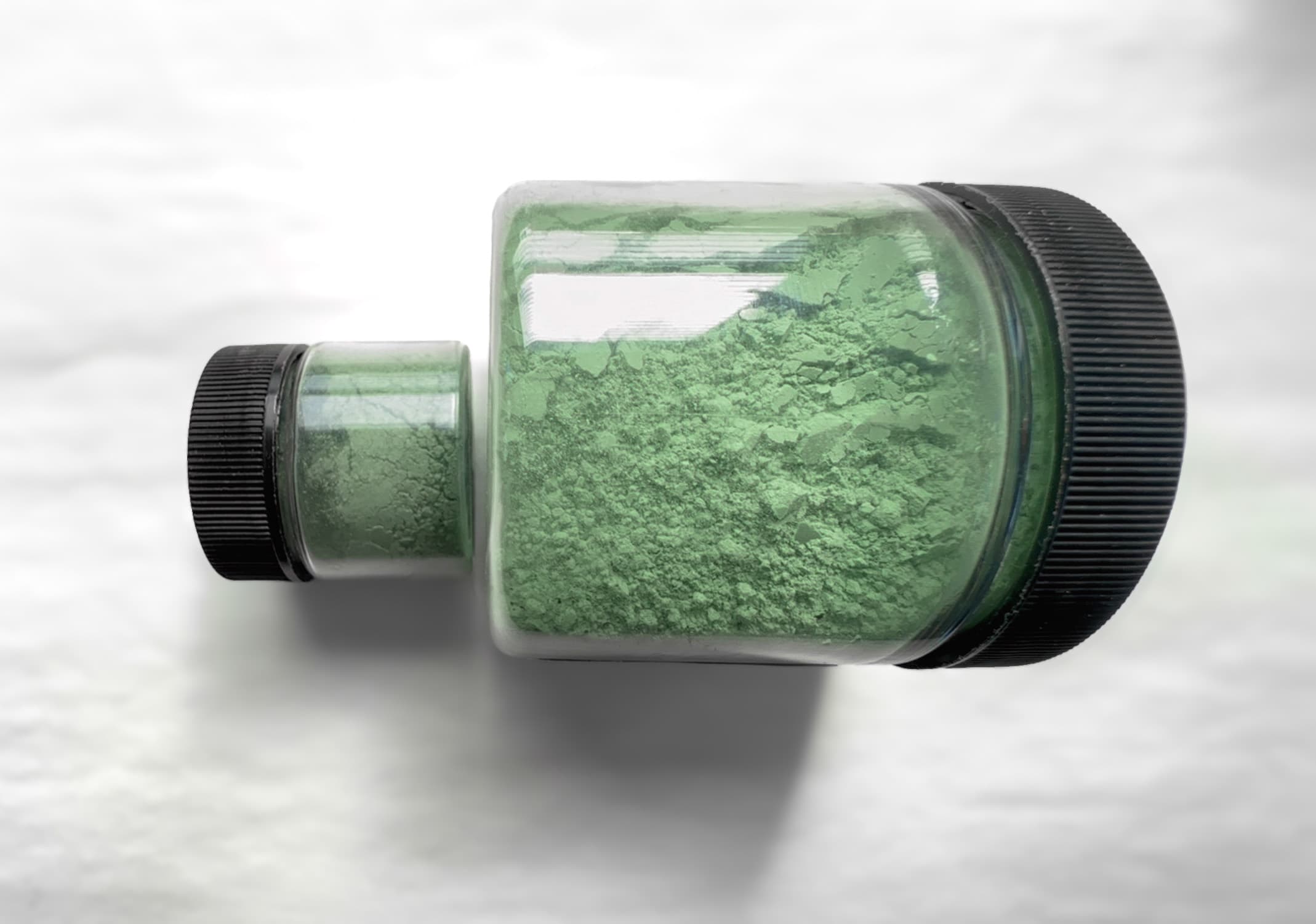 Two jars of dry pigment to illustrate a slight difference in hue between the dry pigments. The Volkonskoite is a bit bluer, but both are a dusty green color